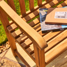 Wooden chair with books on a grassy background