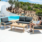 2 chairs, 2 coffee tables in wood and a wood and fabric small sofa with cushions in dark grey