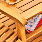 Wooden table with a book and a glass on top