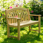 turnberry garden bench with a curved back in a garden.