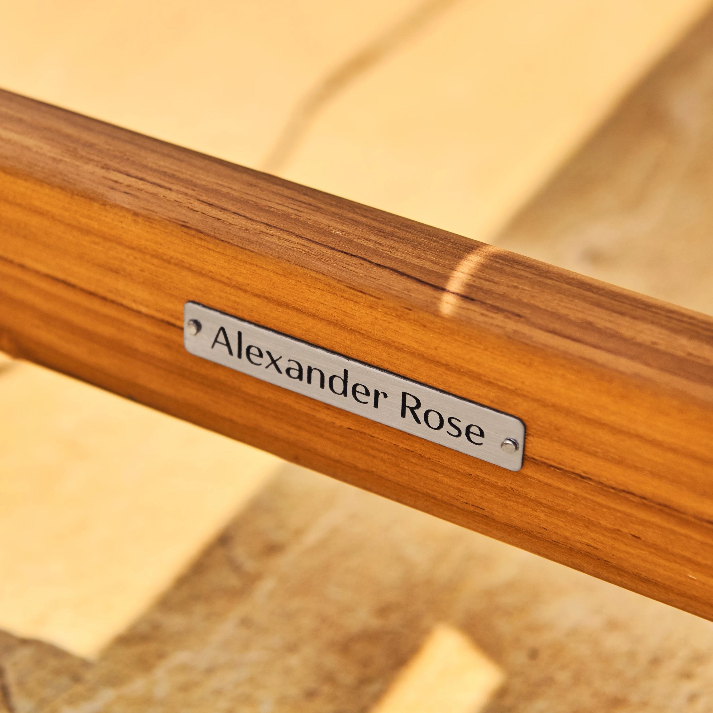 Wooden product with 'Alexander Rose' label on a blurred background