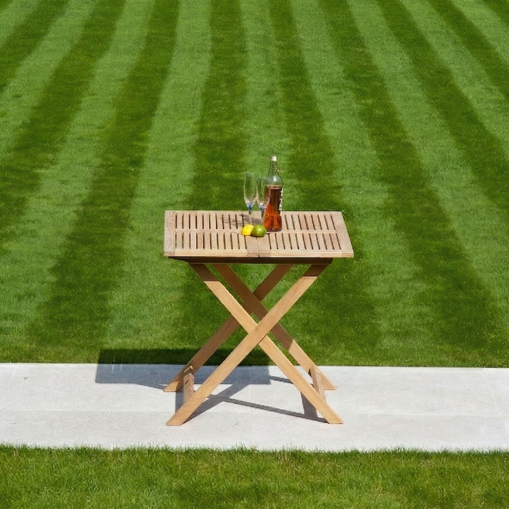 folding square table with drinks and a lawn background