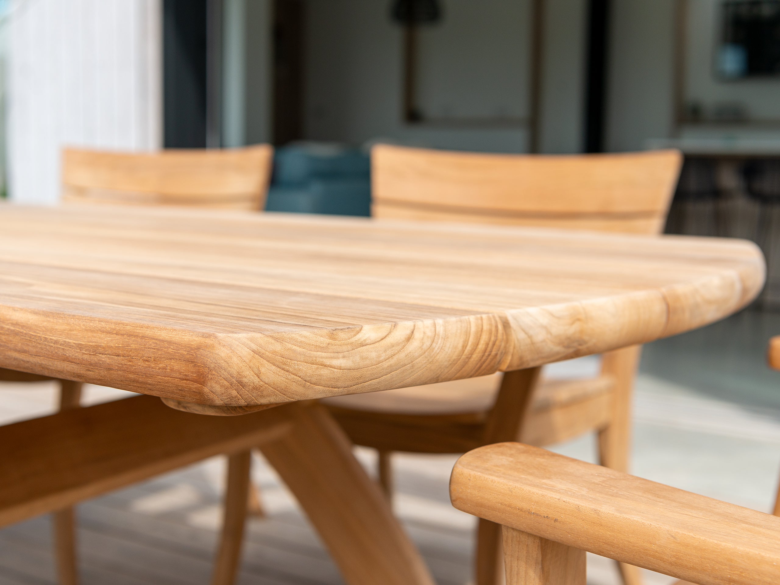 Wooden dining table with chairs in a blurred indoor setting