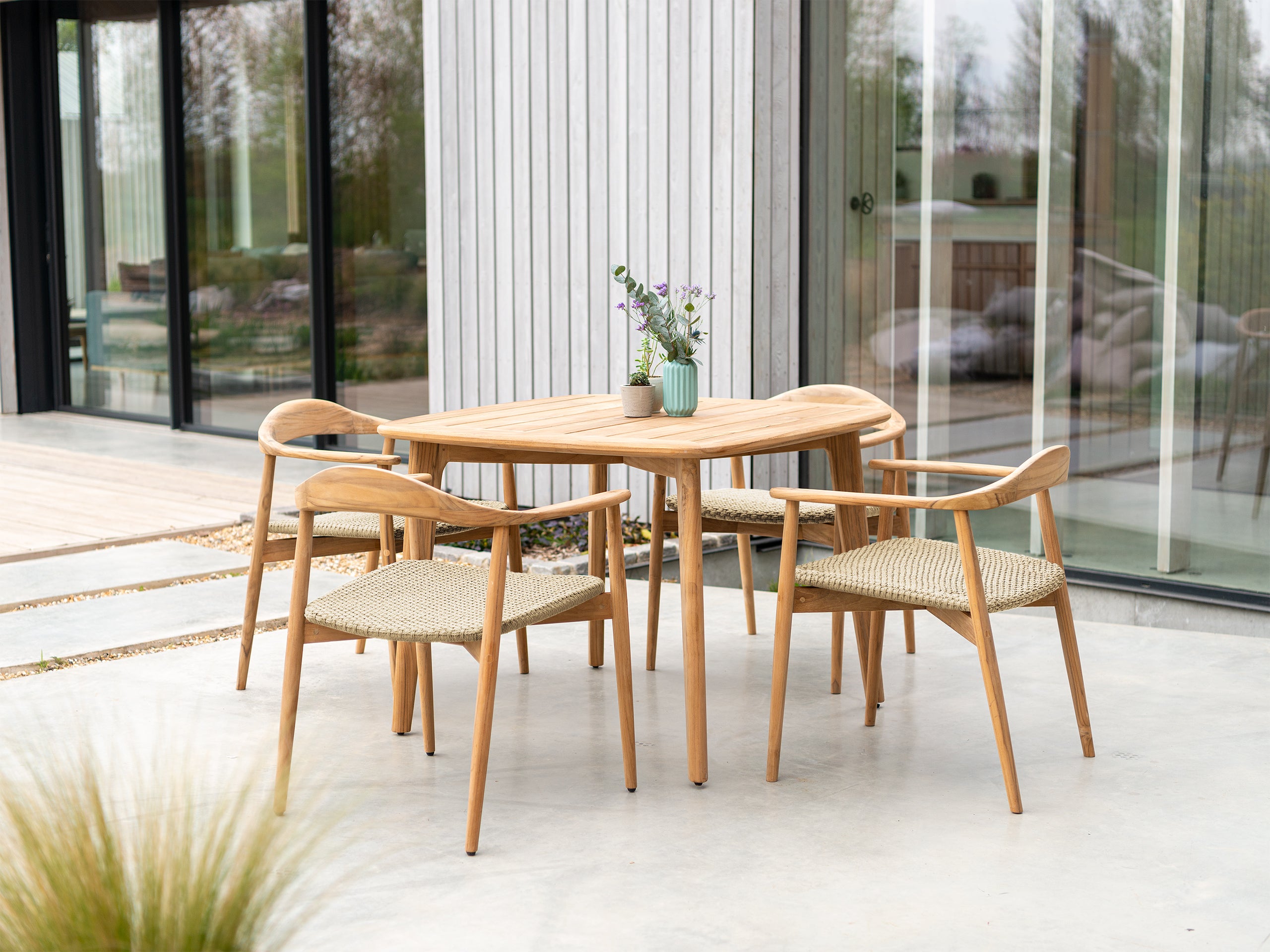 Alexander Rose Dana outdoor patio dining set with 4 rounded armchair dining chairs with woven seats