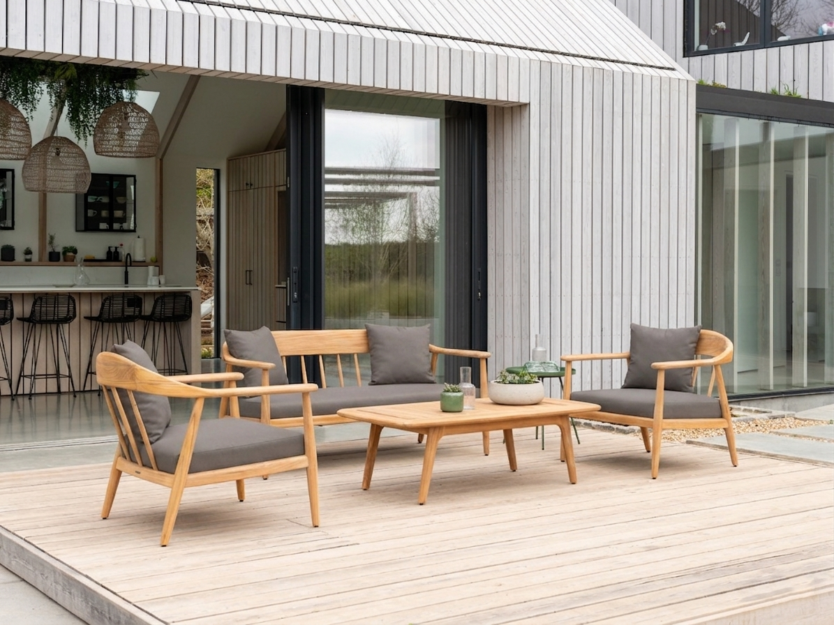 Scandinavian style outdoor patio set with sofa, two chairs all with curved arms and a coffee table