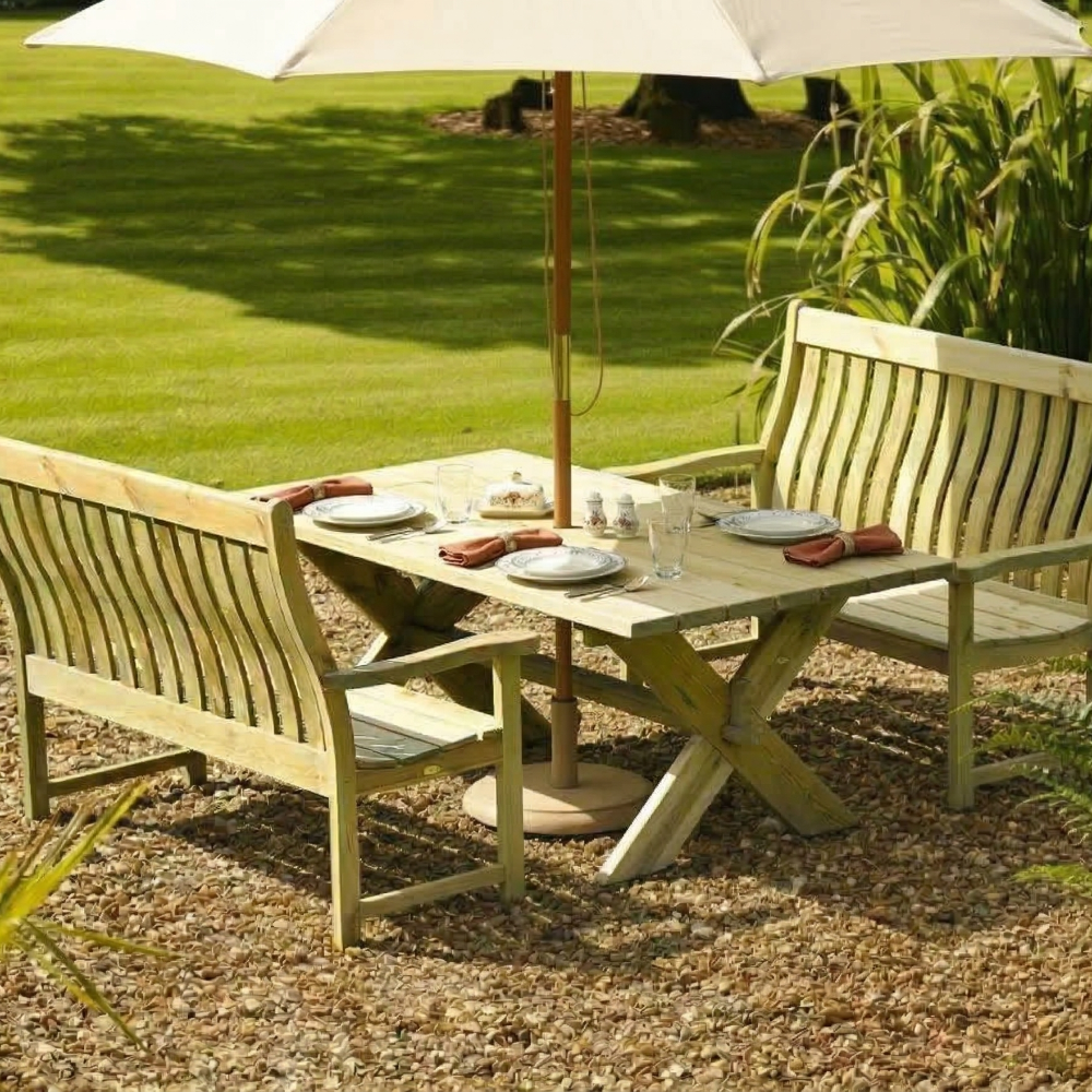 Wooden outdoor furniture set with table and benches under a large umbrella on a grassy area.