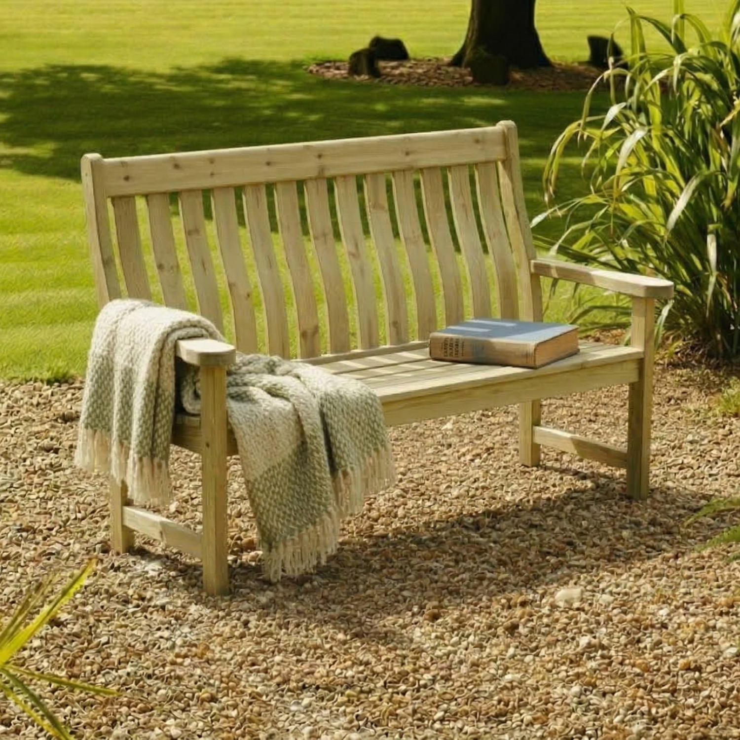 Wooden bench with a blanket and book in a garden setting