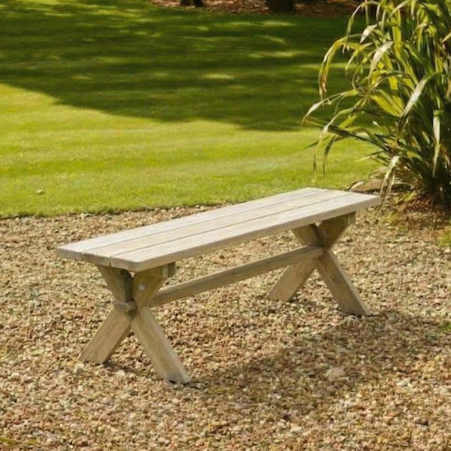 Wooden bench in a garden setting with grass and plants.