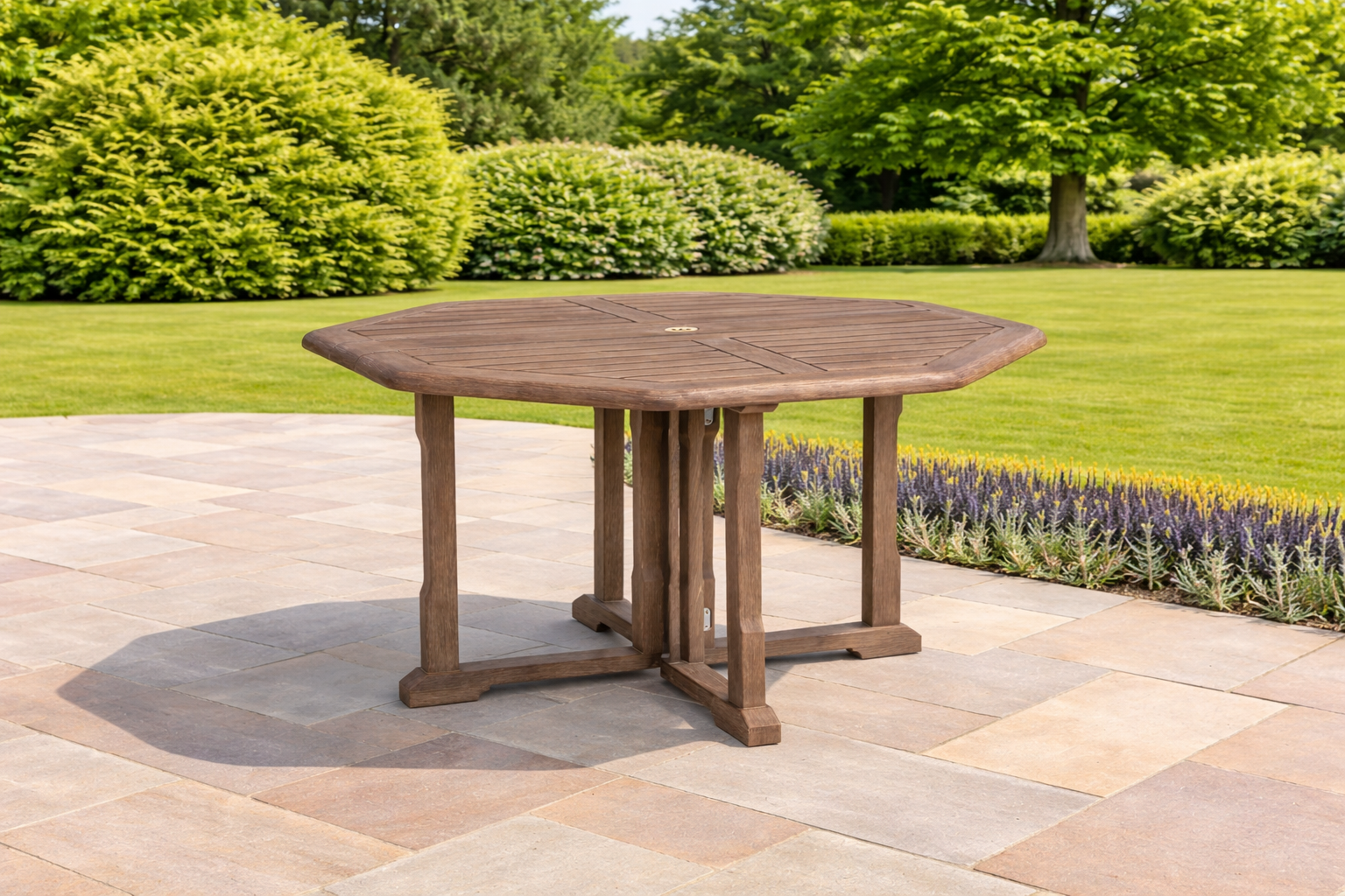 Wooden outdoor table on a patio with greenery in the background