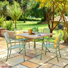 Outdoor patio set with table and chairs on a stone patio