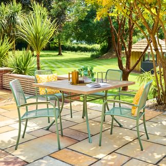Outdoor patio set with table and chairs on a stone patio
