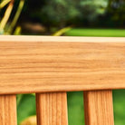 Close-up of a wooden surface with a blurred green background