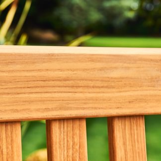 Close-up of a wooden surface with a blurred green background