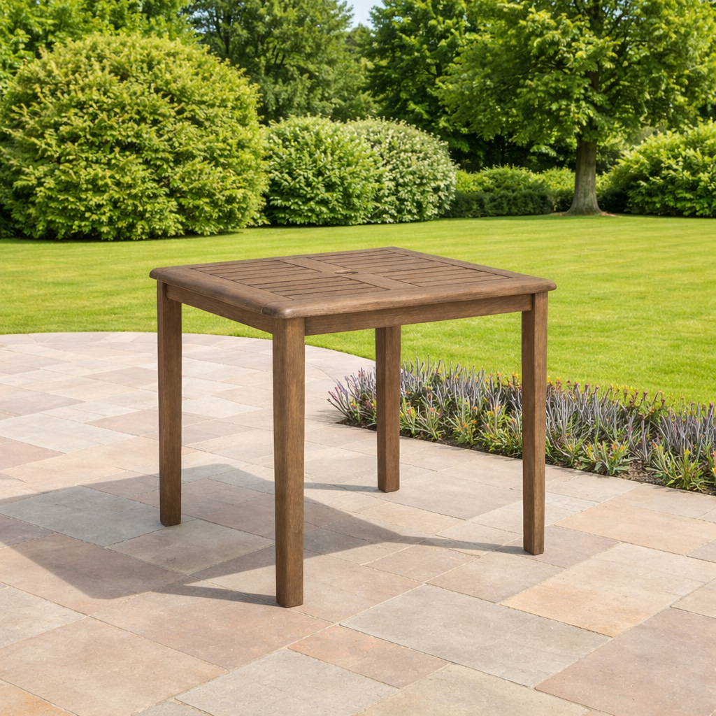 Wooden outdoor table on a patio with greenery in the background
