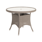 Round outdoor table with wicker frame and glass top on a white background