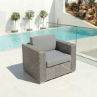 Monte Carlo lounge chair on a terrace beside a swimming pool under natural daylight.