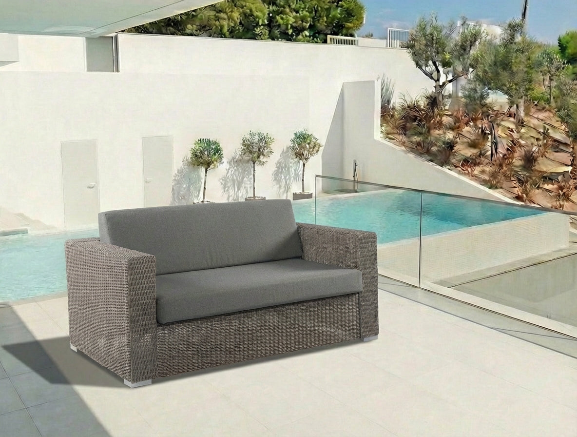 Grey outdoor 2-seater sofa with by a poolside