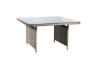Square outdoor dining table with wicker frame and glass top on a white background