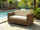Luxury Rattan outdoor sofa with beige cushions by a poolside