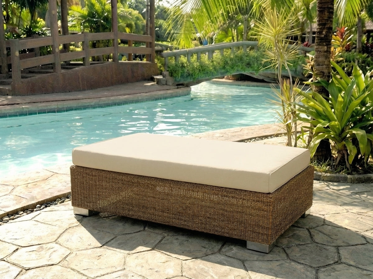 Luxury rattan outdoor lounge chair with beige cushion by a poolside