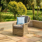 Luxury rattan dining armchair on a patio