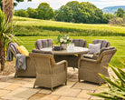 Outdoor patio set with round table and chairs in a garden setting
