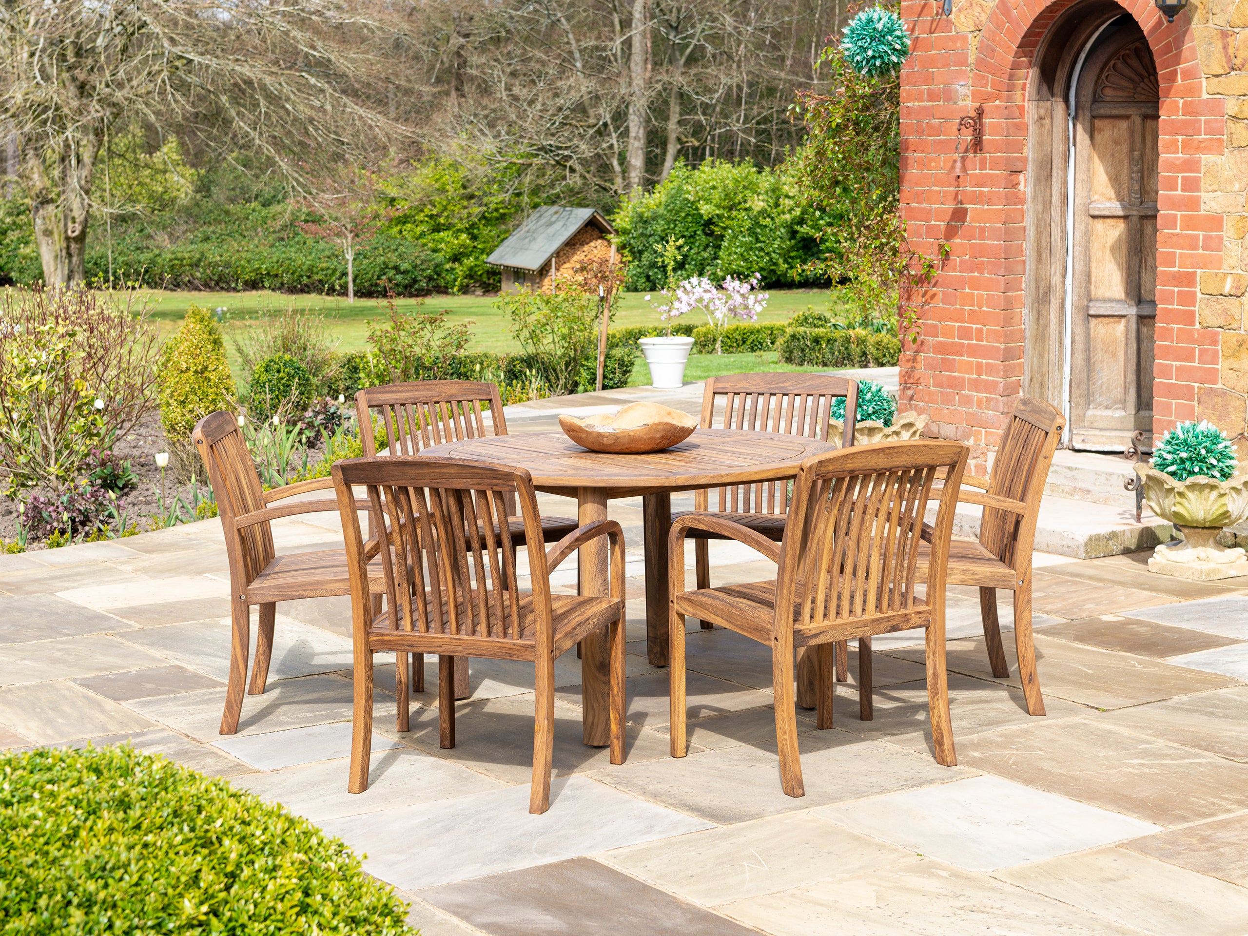 Bolney Dark Acacia Round Table 1.3m, paired with Bolney Acacia Chairs. 