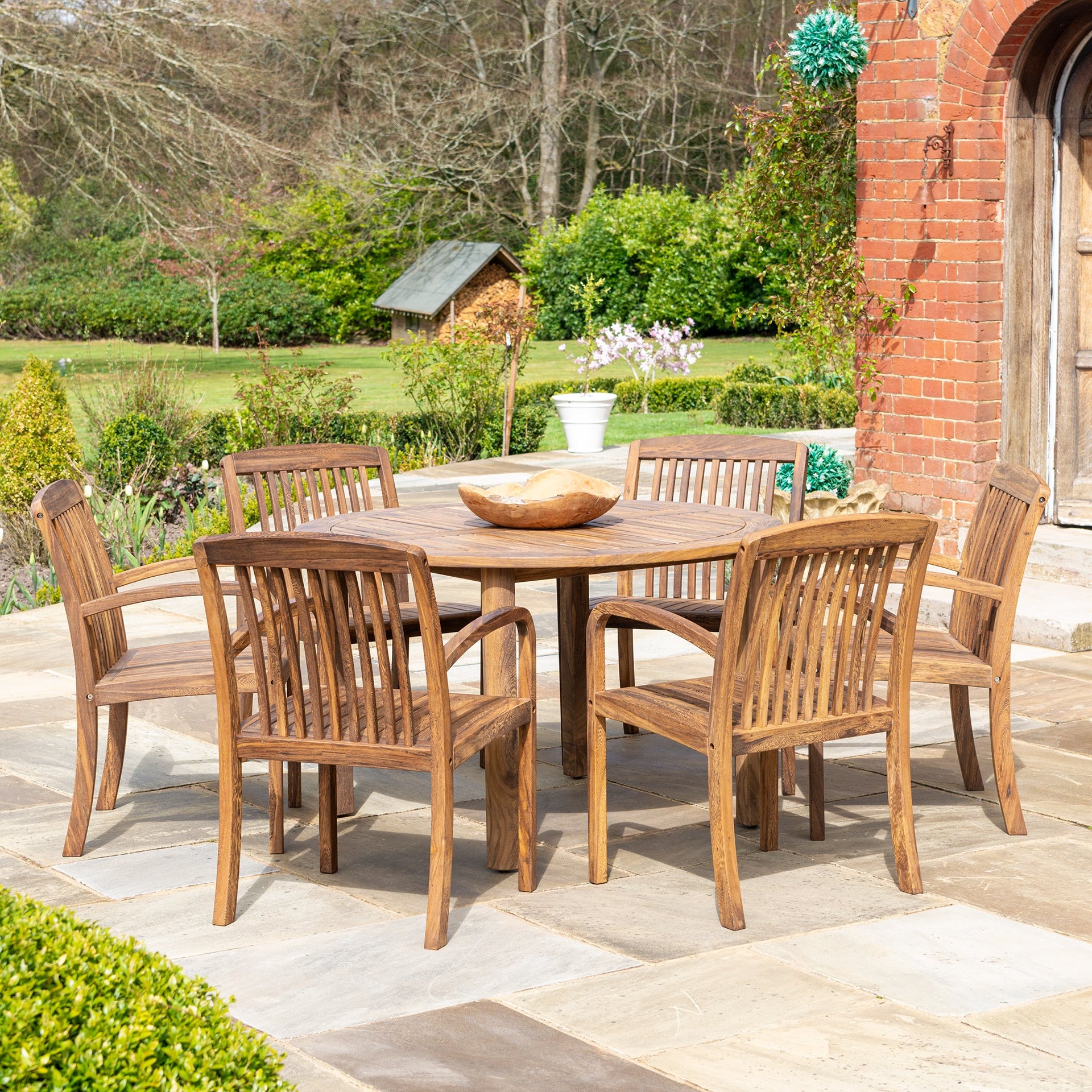 Bolney Dark Acacia Round Table 1.3m, paired with Bolney Acacia Chairs. 