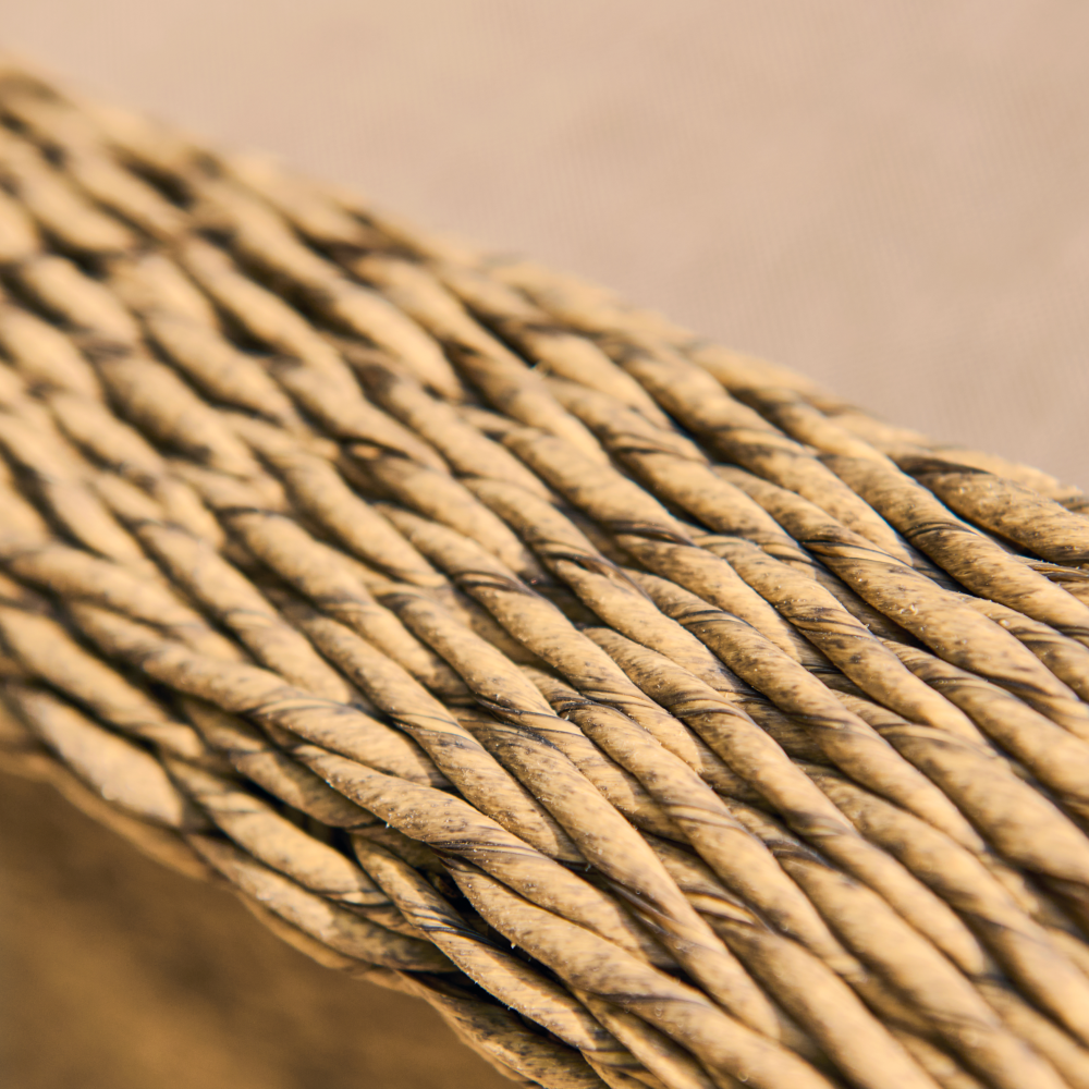 Close-up of braided beige cable on a beige background