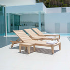 3 alexander rose sunbeds adjacent a pool with side tables