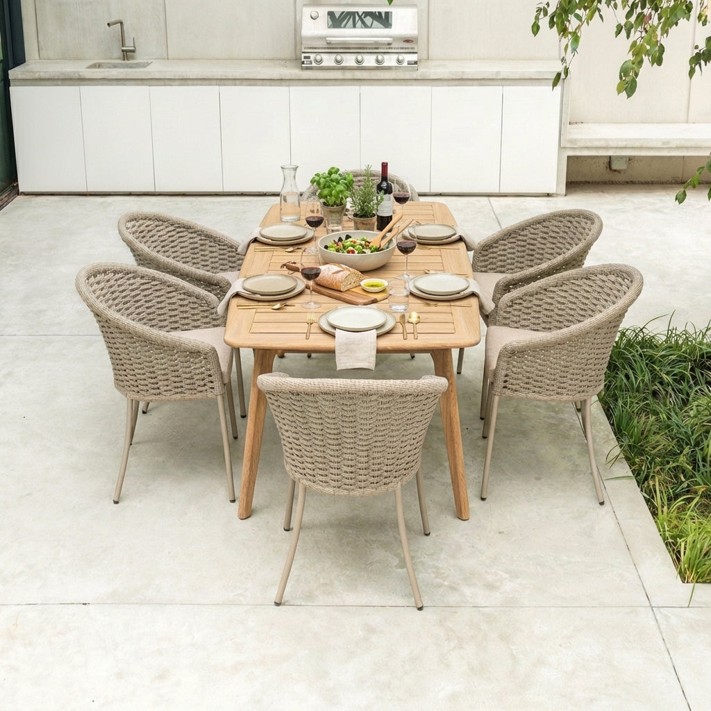 Outdoor dining setup with a wooden table and rope chairs on a patio.