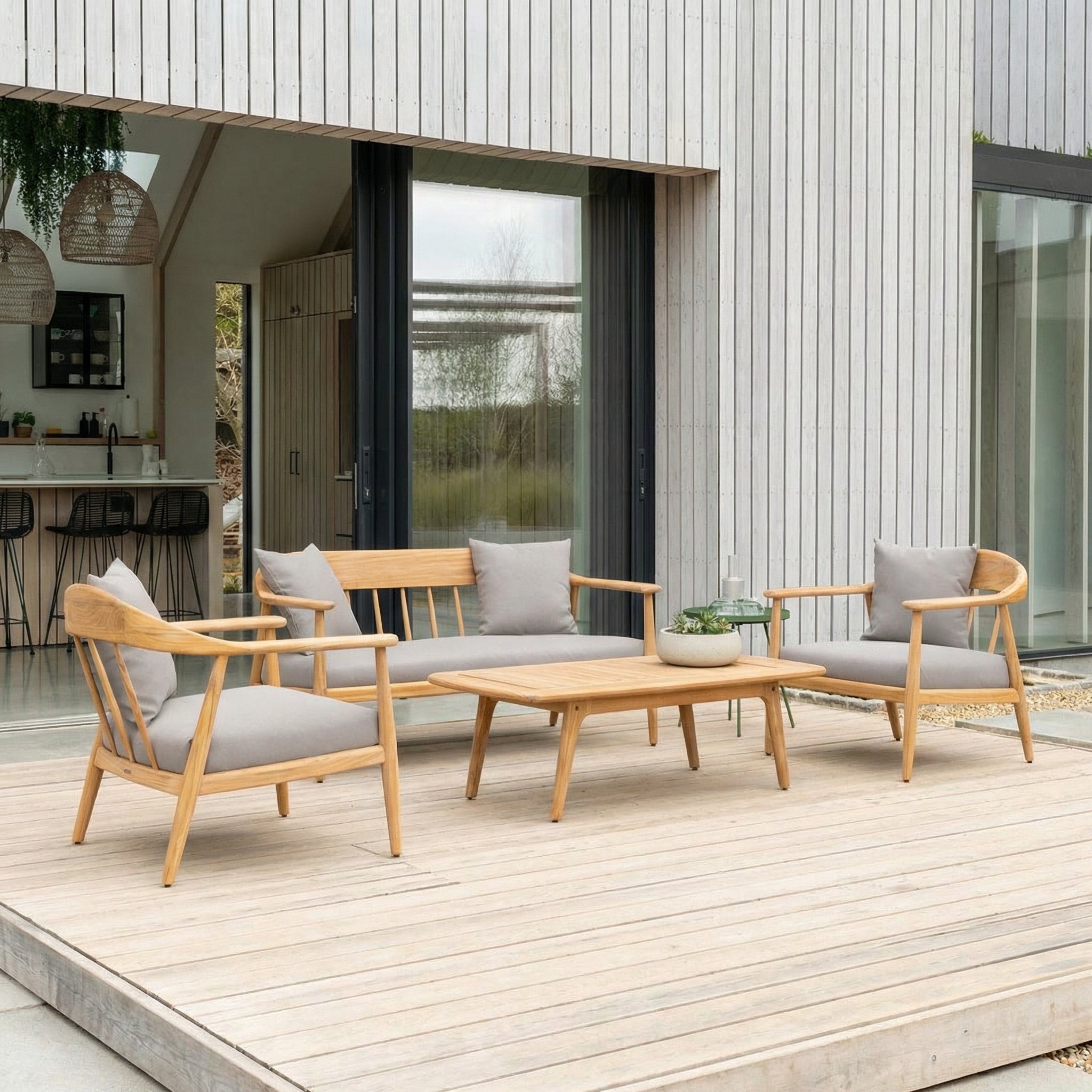 Outdoor furniture set with wooden chairs and table on a deck.