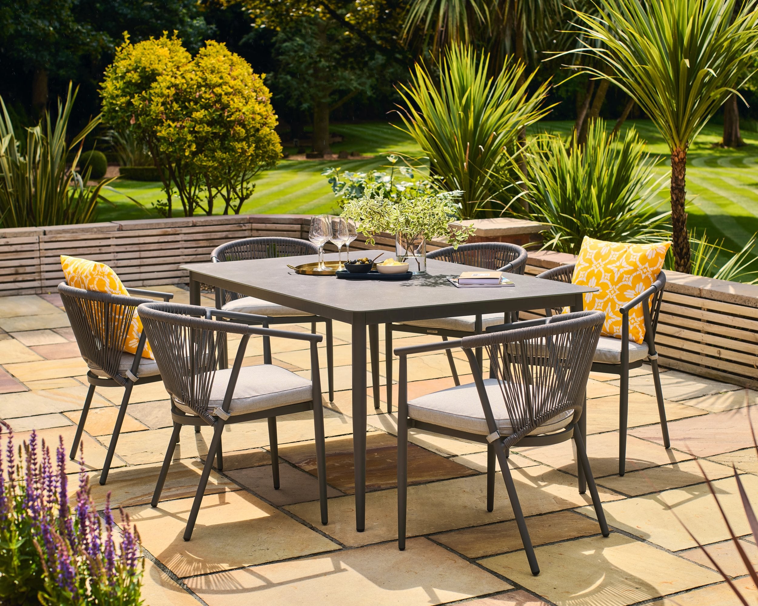 Outdoor patio set with table and chairs on a sunny day
