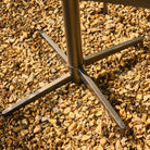 Metal stand on a bed of small stones
