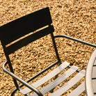 Black metal chair on a gravel surface