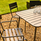 Garden table and chairs with glasses on a gravel patio