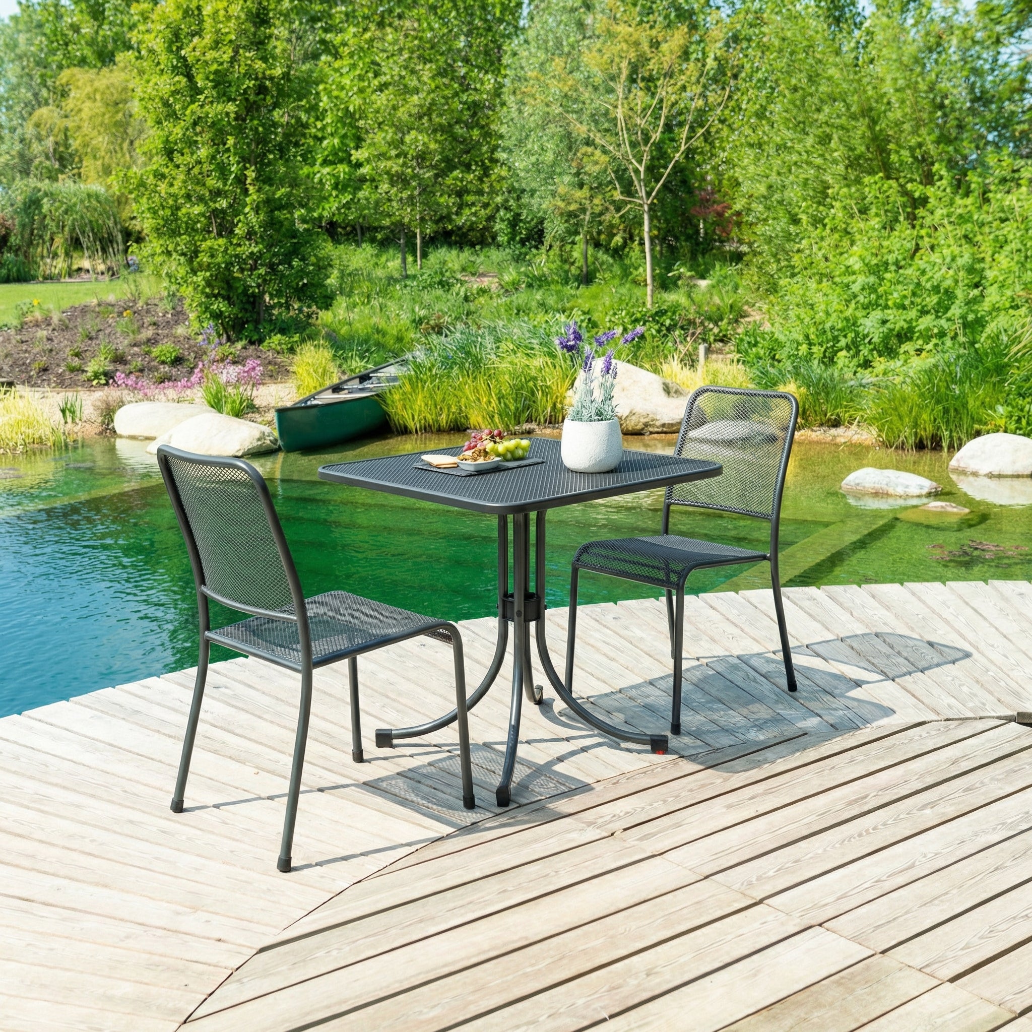 Outdoor patio set with table and chairs by a pool