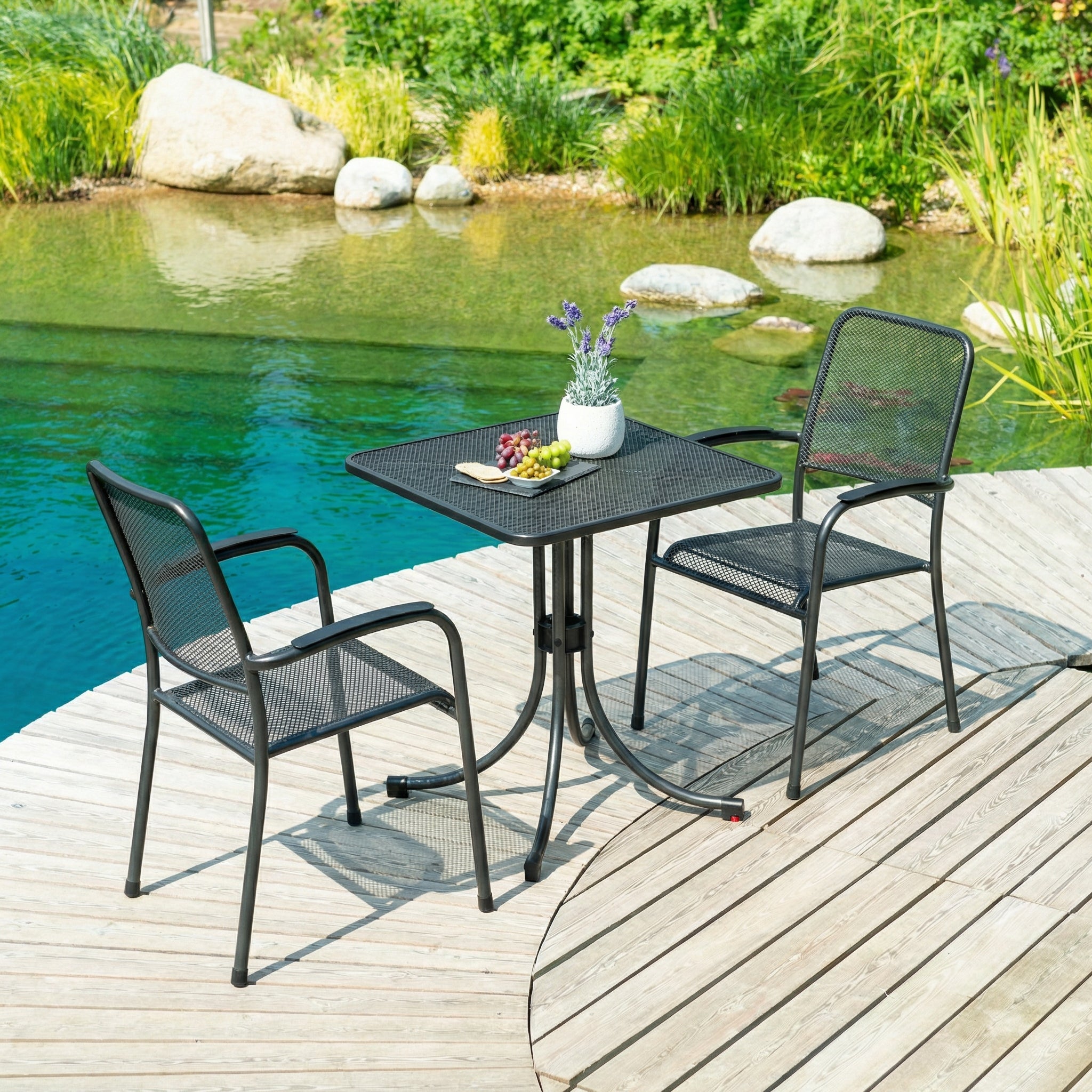 Outdoor patio set with table and chairs by a pool