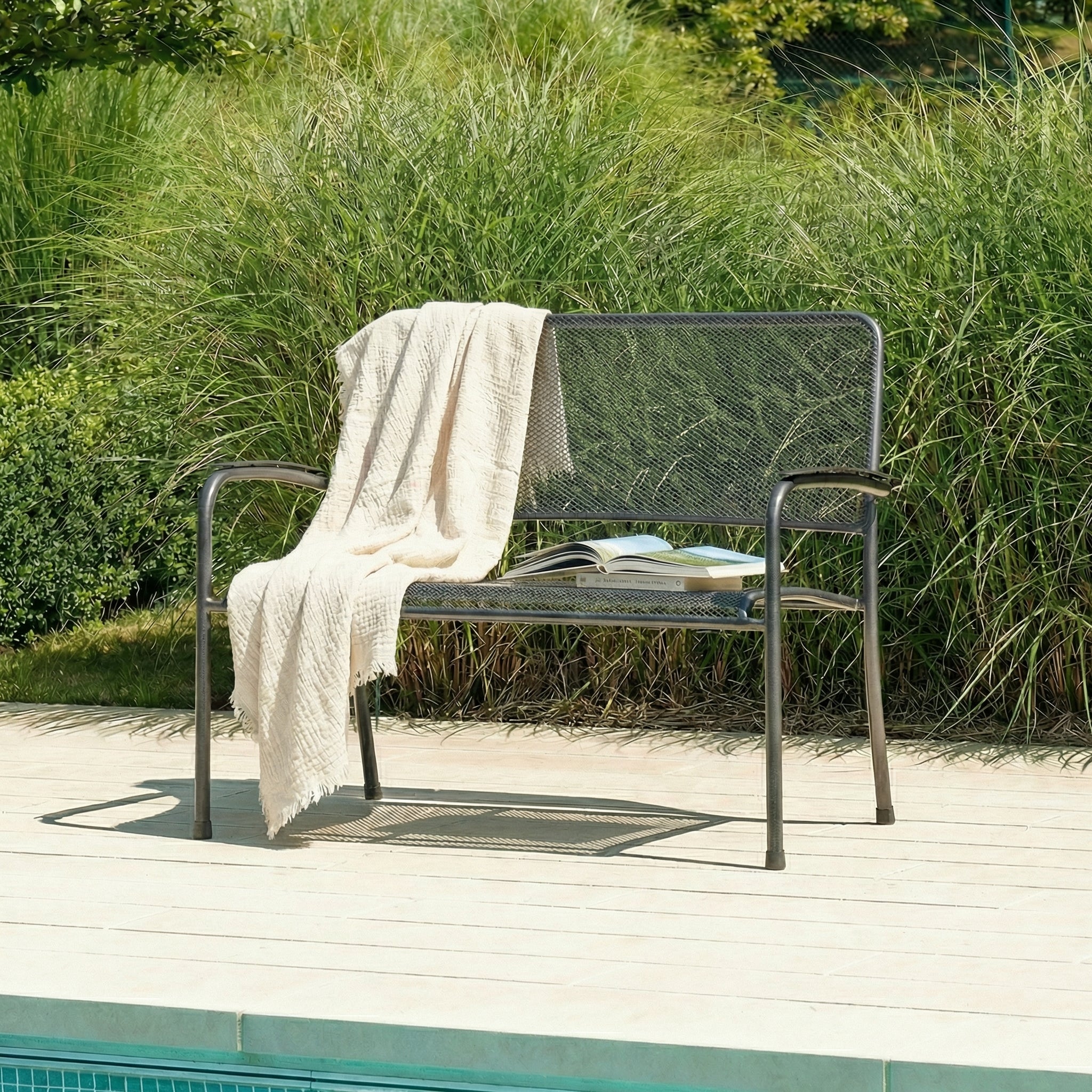 Metal 2-seater bench with a cream throw