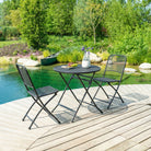 Outdoor patio set with table and chairs by a pool