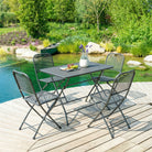 Outdoor patio set with table and chairs by a pond