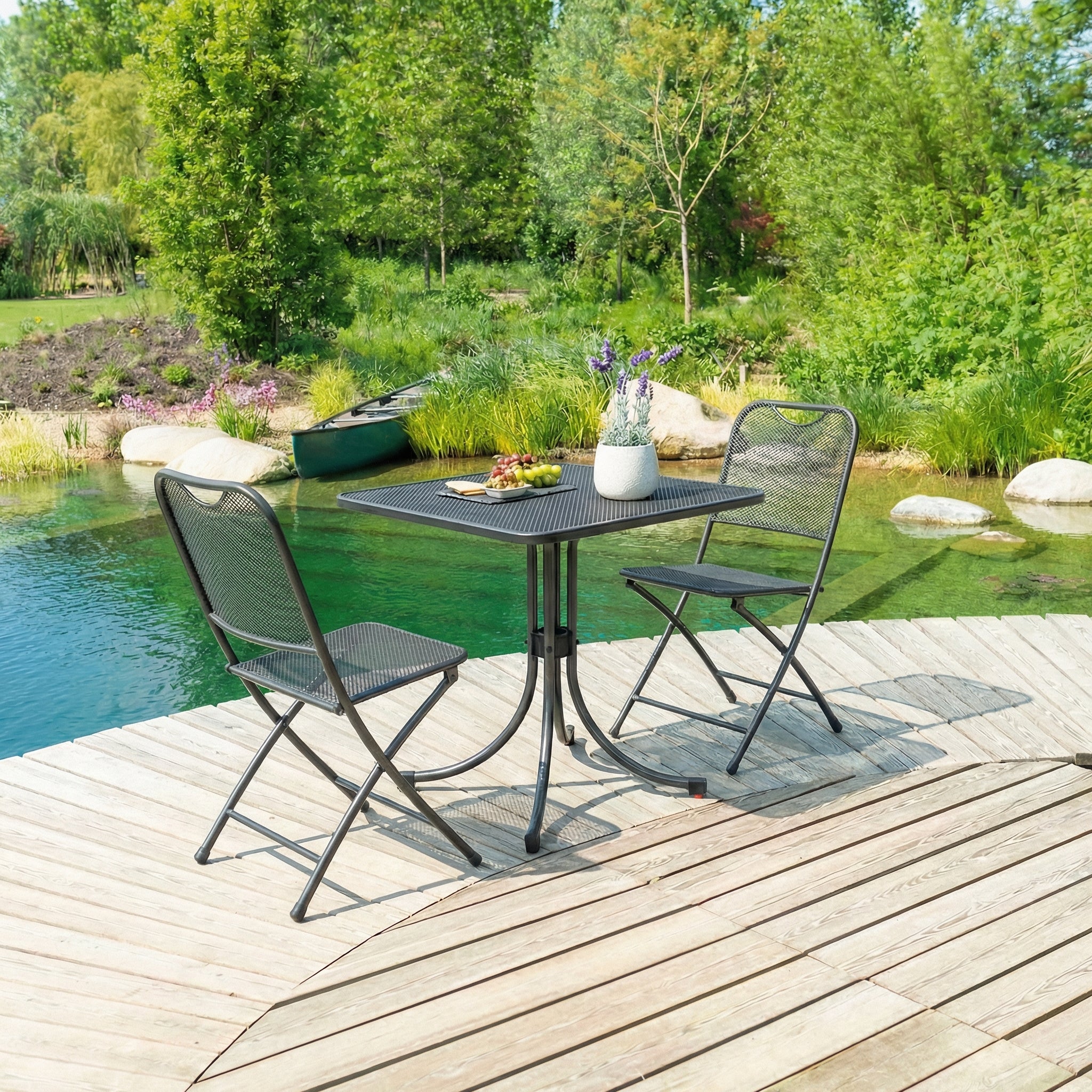 Outdoor patio set with table and chairs by a pond