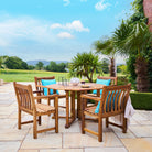 Wooden outdoor dining set with chairs and table in a garden setting