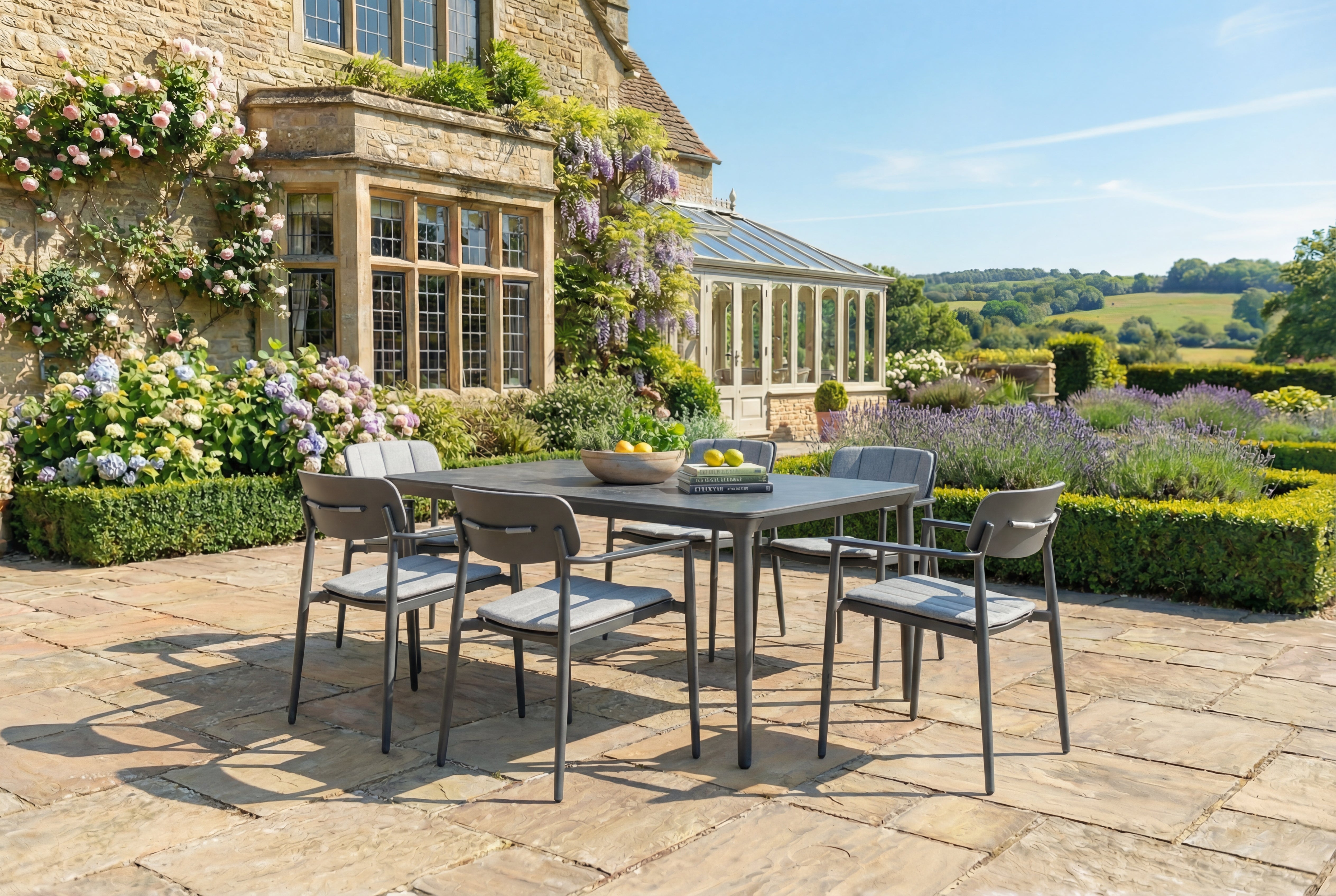 Outdoor dining set on a stone patio with a garden and building in the background