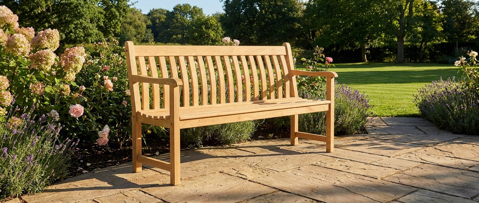 Wooden bench in a garden setting with flowers and trees