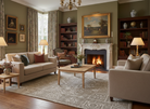 Cozy living room with fireplace, bookshelves, and comfortable seating.