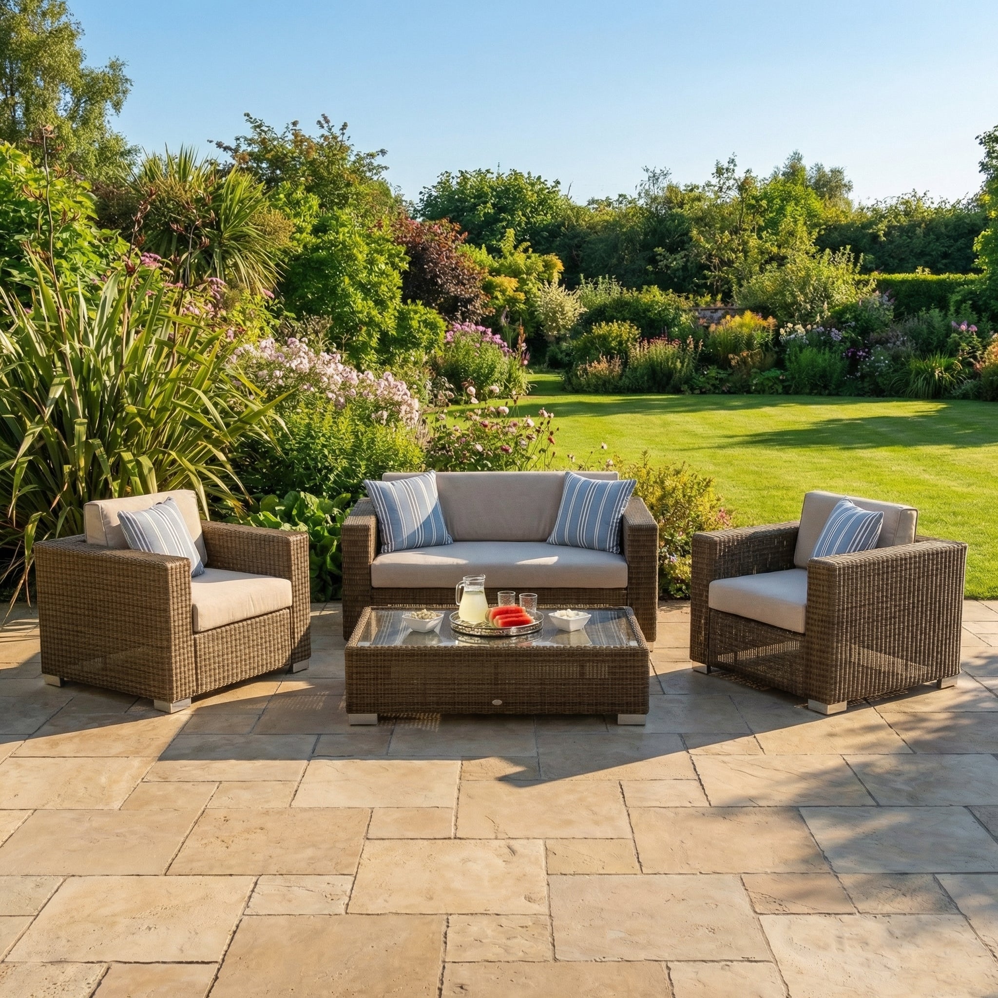 Luxury rattan outdoor patio set with cushions in a garden setting