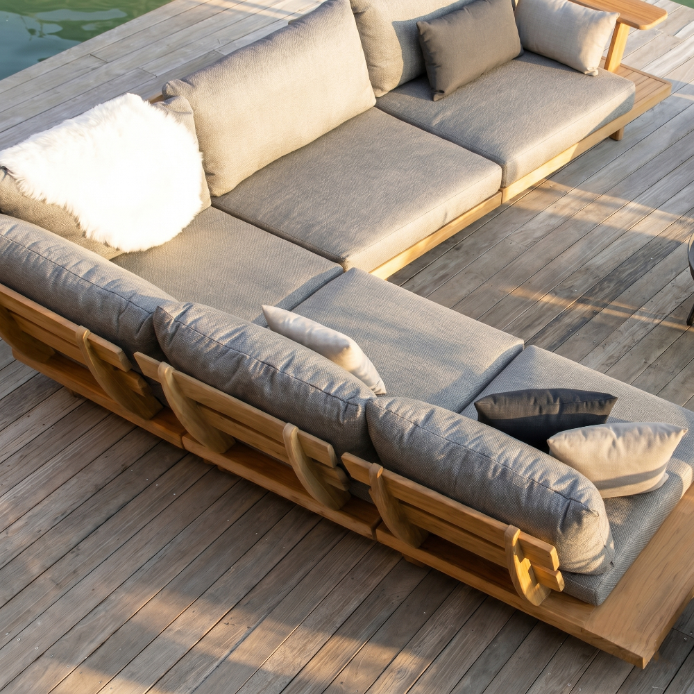 Modular outdoor sofa with cushions on a wooden deck