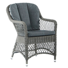 Wicker armchair with gray cushion on a white background