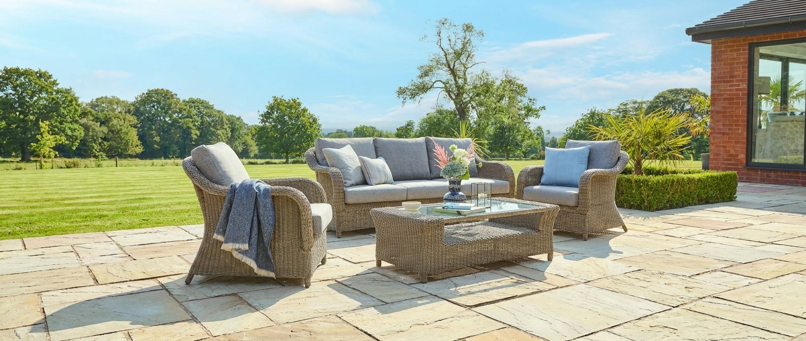 Outdoor patio set with furniture on a stone patio area.